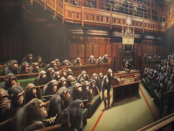 Troy Mclure: The movie or the planet?

This is part of a large painting of The House of Commons by Banksy, the anonymous UK graffiti artist displayed in the Bristol Museum throughout Summer 2009. While the bulk of his work are pretty much visual jokes, this particular exhibition also used some pretty amazing animatronics to explore the relationships between man and animals. Link pending!